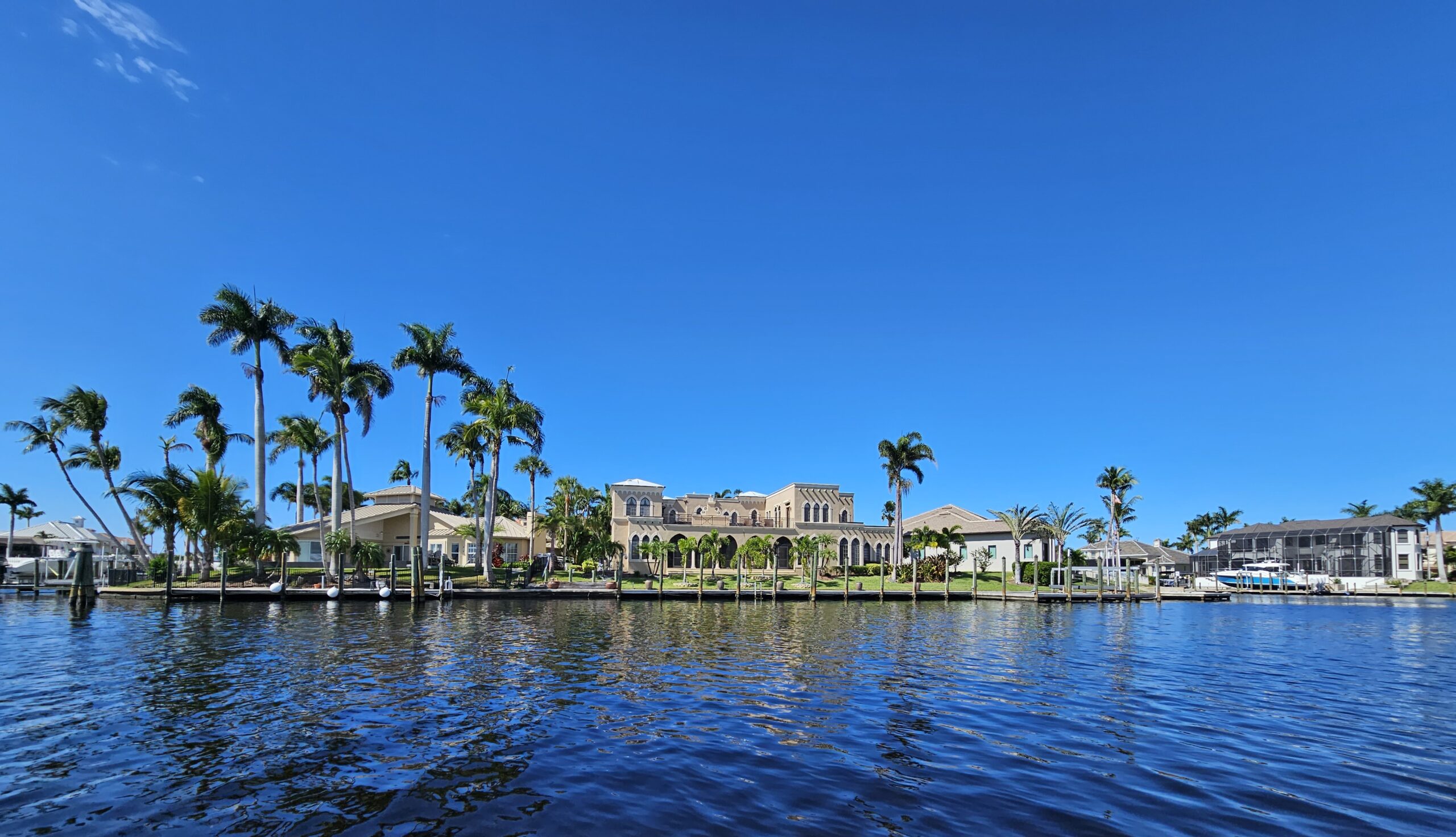 Luxury waterfront homes along a Cape Coral canal viewed from the water
